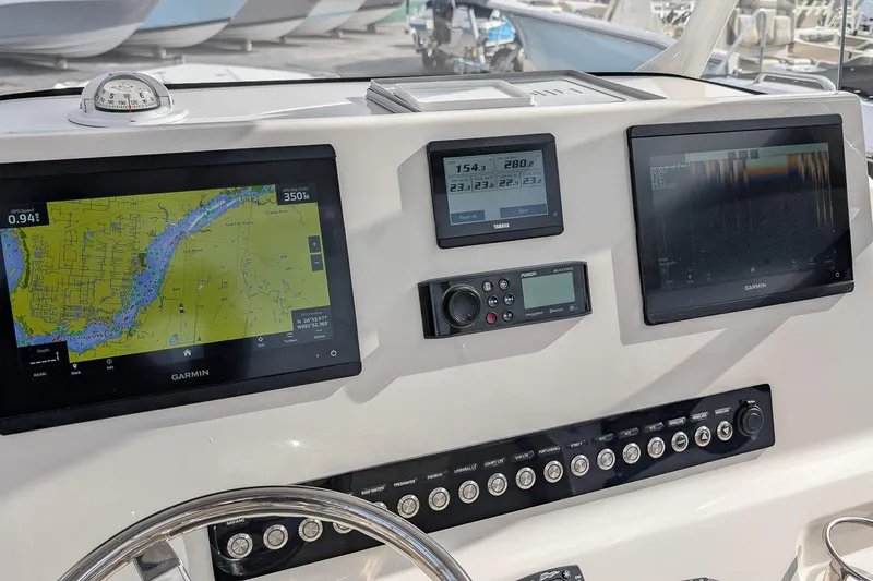 Slide: The Image of 2023 Key West 263 FS boat dashboard with Garmin navigation displays and controls. - 17