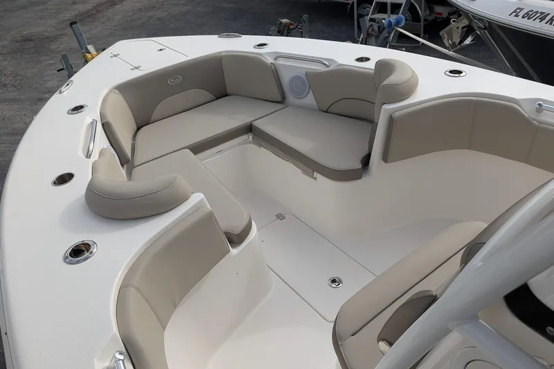 Slide: The Image of 2023 Key West 263 FS boat interior with beige seating and cup holders. - 19