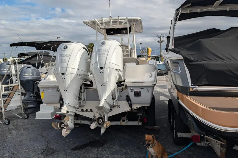Slide: The Image of 2023 Key West 263 FS boat with twin Yamaha engines in a marina. - 3