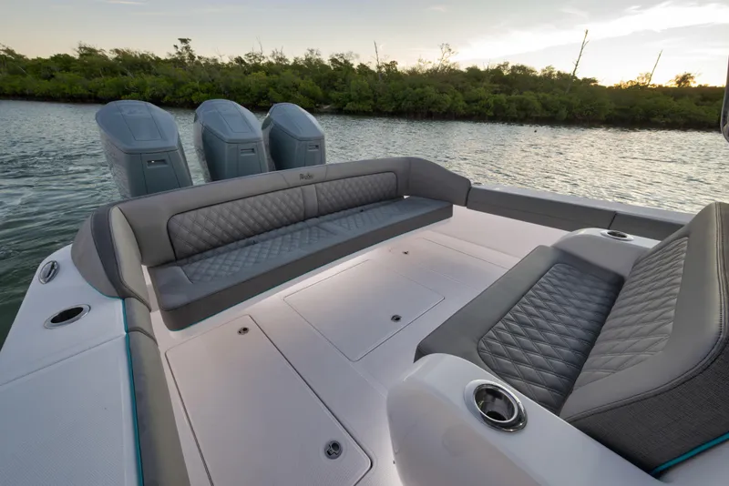 Slide: The Image of 2026 Mag Bay 43 CC boat interior with luxurious seating and triple outboard engines. - 12