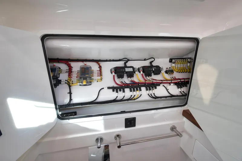 Slide: The Image of Electrical panel of 2026 Mag Bay 43 CC boat, showcasing organized wiring and components. - 17