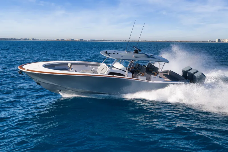 Slide: The Image of 2026 Mag Bay 43 CC cruising on open water, showcasing sleek design and powerful engines. - 3