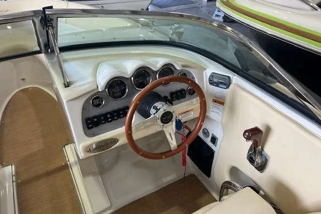 Slide: The Image of 2011 Chris-Craft Launch 22 boat dashboard with wooden steering wheel and instrument panel. - 13