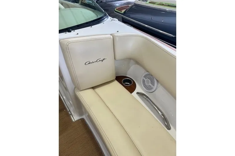 Slide: The Image of 2011 Chris-Craft Launch 22 boat interior with beige seating and speaker detail. - 18