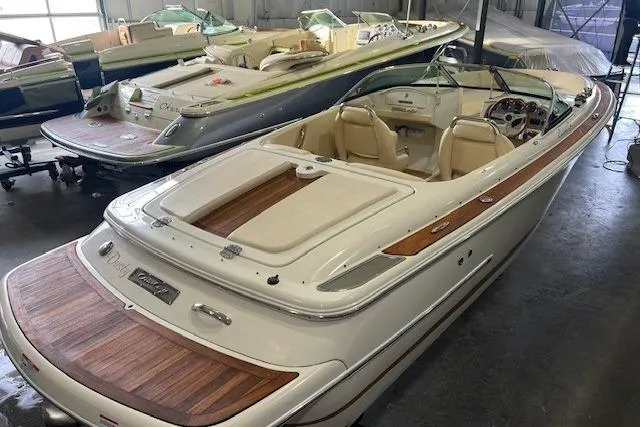 Slide: The Image of 2011 Chris-Craft Launch 22 boat with elegant wood detailing in a showroom. - 2