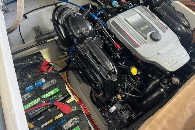Slide: The Image of Engine compartment of a 2011 Chris-Craft Launch 22 boat, featuring batteries and engine components. - 25