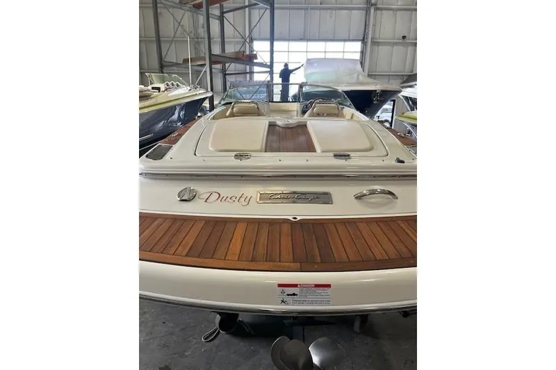 Slide: The Image of 2011 Chris-Craft Launch 22 boat with wooden deck, stored indoors. - 5
