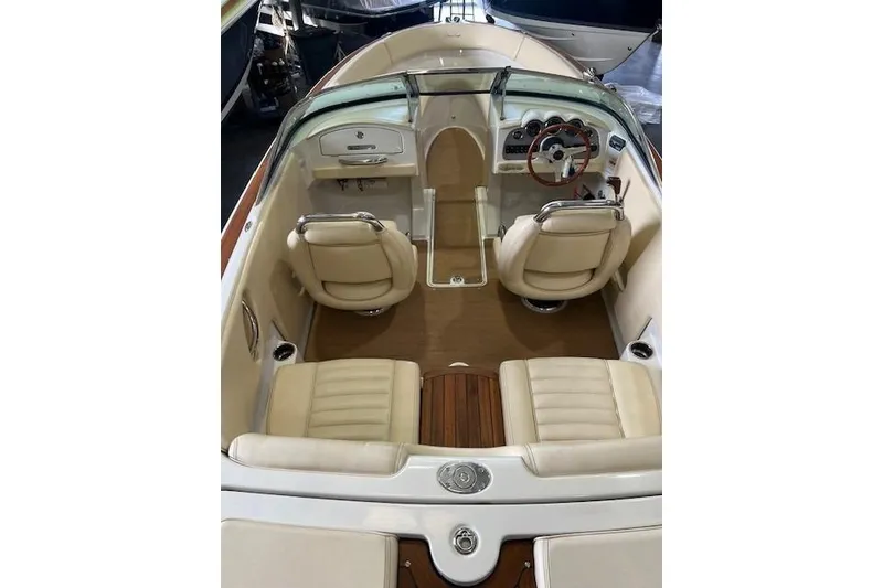 Slide: The Image of 2011 Chris-Craft Launch 22 boat interior with beige seating and wooden accents. - 8
