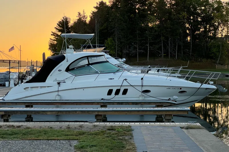 The Image of 2006 Sea Ray 38 Sundancer yacht docked at sunset. - 0