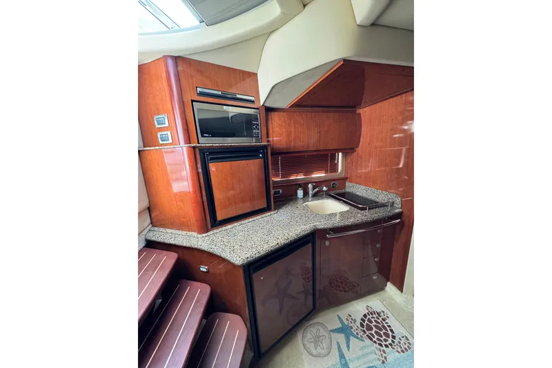 Slide: The Image of 2006 Sea Ray 38 Sundancer yacht kitchen with wood cabinetry and granite countertops. - 17