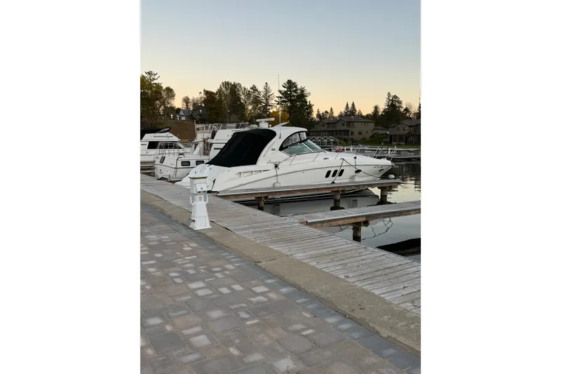 Slide: The Image of 2006 Sea Ray 38 Sundancer yacht docked at marina during sunset. - 2