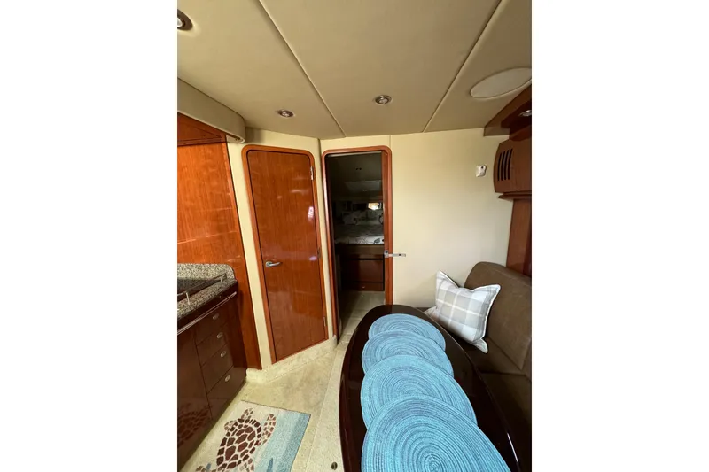 Slide: The Image of Interior of 2006 Sea Ray 38 Sundancer yacht with elegant wood finishes and cozy seating. - 20