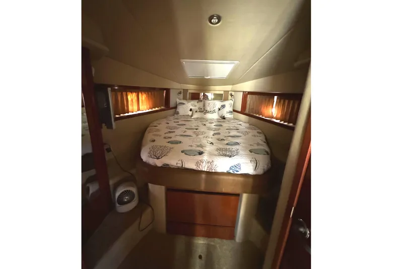 Slide: The Image of Interior cabin of 2006 Sea Ray 38 Sundancer with cozy bed and nautical decor. - 21