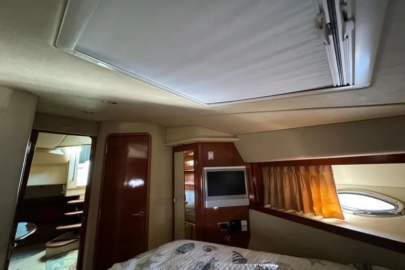 Slide: The Image of Interior cabin of 2006 Sea Ray 38 Sundancer with TV, window, and bed. - 22