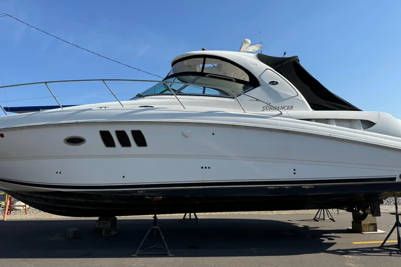 Slide: The Image of 2006 Sea Ray 38 Sundancer yacht on dry dock under clear blue sky. - 3