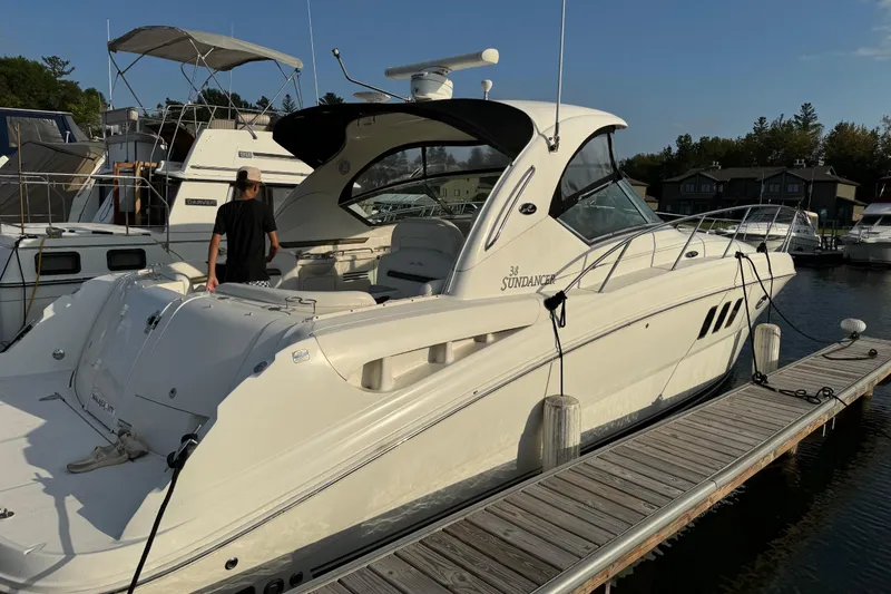 Slide: The Image of 2006 Sea Ray 38 Sundancer yacht docked at marina, featuring sleek design and spacious deck. - 4