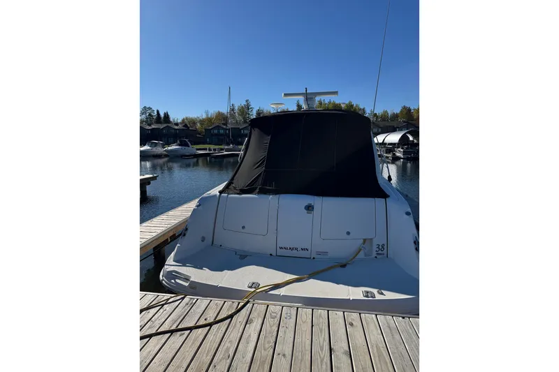 Slide: The Image of 2006 Sea Ray 38 Sundancer docked at marina under clear blue sky. - 5