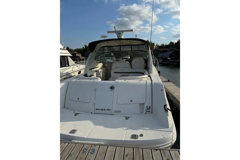 Slide: The Image of 2006 Sea Ray 38 Sundancer yacht docked at marina under blue sky. - 6