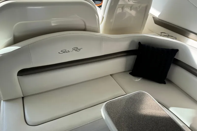 Slide: The Image of 2006 Sea Ray 38 Sundancer interior with white seating and black cushion. - 9