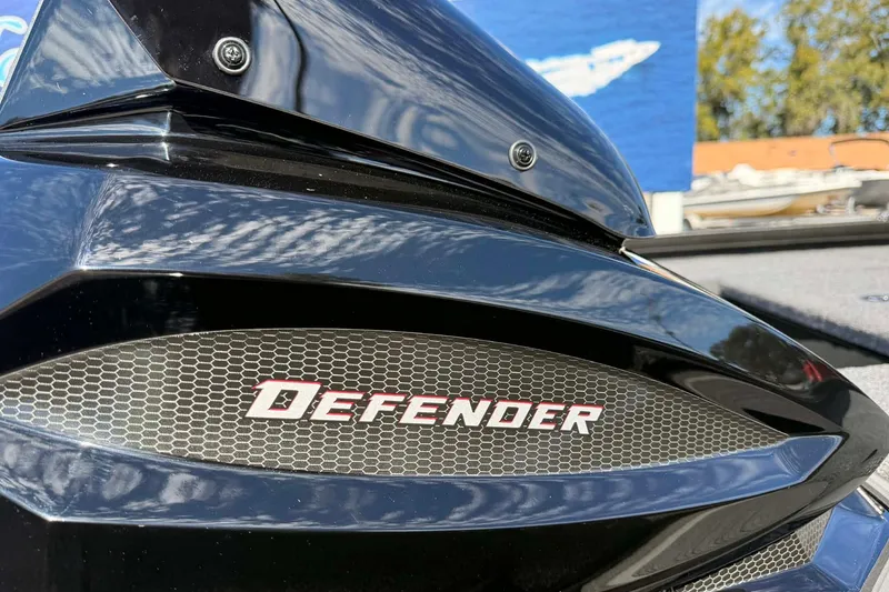 Slide: The Image of Close-up of 2026 Vexus Defender 181 boat logo on sleek black surface. - 2