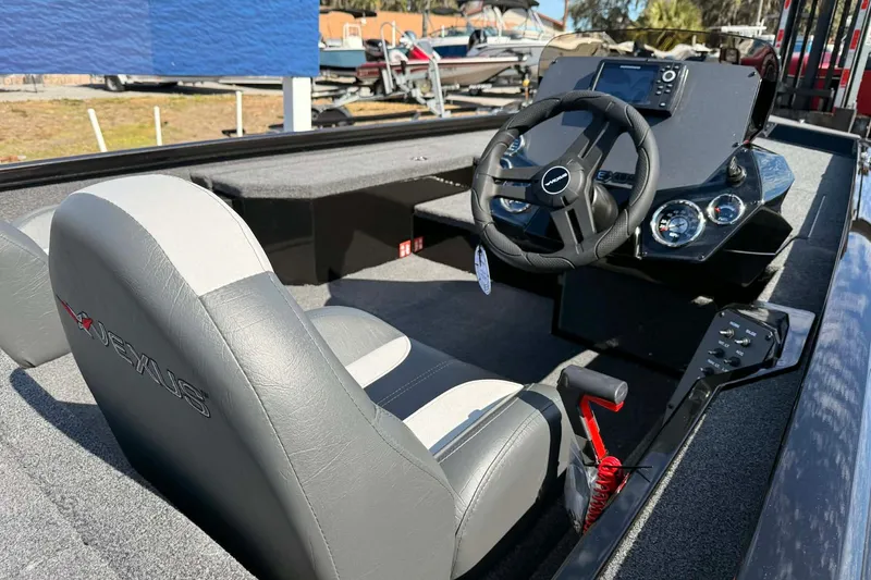 Slide: The Image of 2026 Vexus Defender 181 boat interior with steering wheel and dashboard controls. - 4