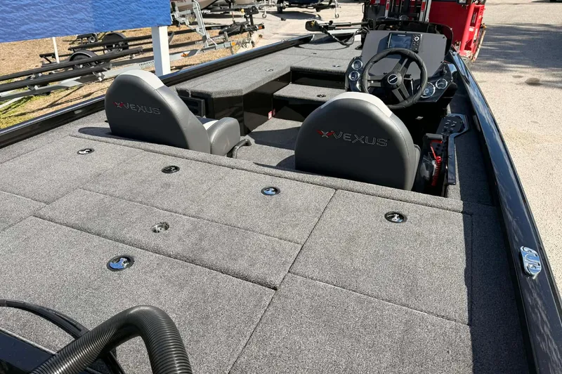 Slide: The Image of 2026 Vexus Defender 181 boat interior with gray seating and spacious deck layout. - 9