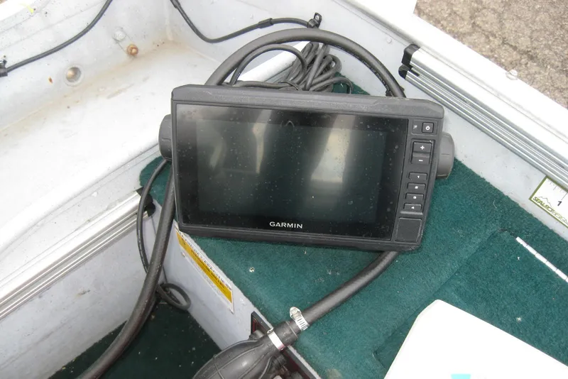 Slide: The Image of Garmin device on 1999 Lund 1440-V Rebel Tiller boat with green carpet interior. - 11