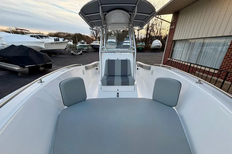 Slide: The Image of 2026 Cape Horn 22 OS boat interior with seating, parked in a marina. - 4