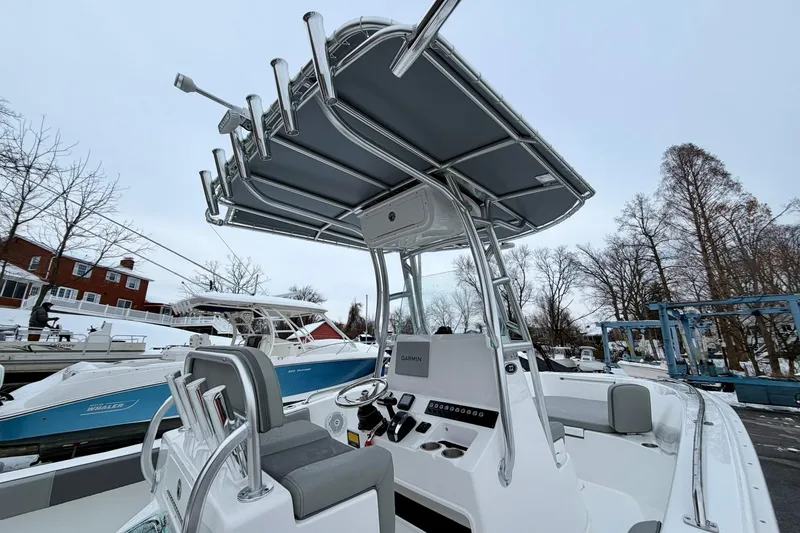 Slide: The Image of 2026 Cape Horn 22 OS boat with T-top and console, docked in a marina. - 11
