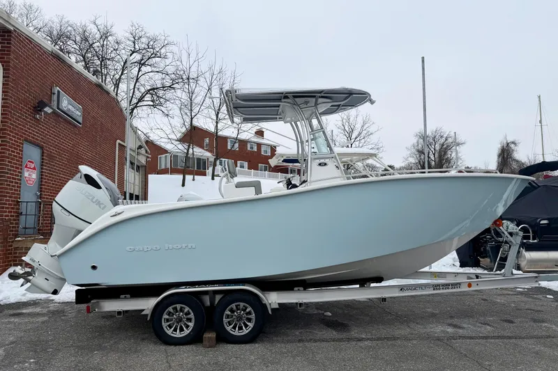 Slide: The Image of 2026 Cape Horn 22 OS boat on trailer with Suzuki outboard motor. - 2