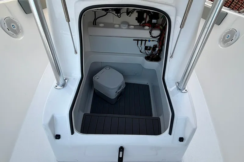 Slide: The Image of 2026 Cape Horn 22 OS boat interior with storage compartment and portable toilet. - 5