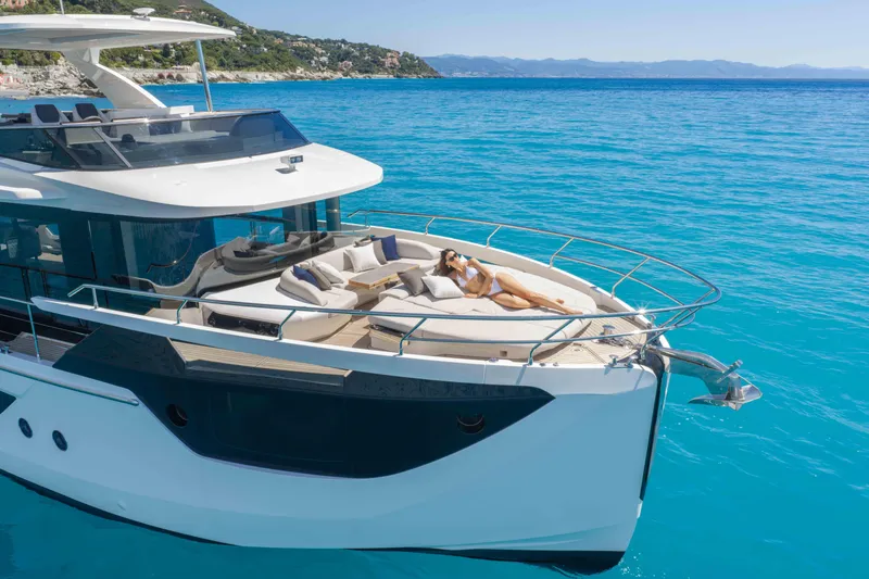 Slide: The Image of Luxury Absolute Navetta 58 yacht cruising in clear blue waters, 2026 model. - 20