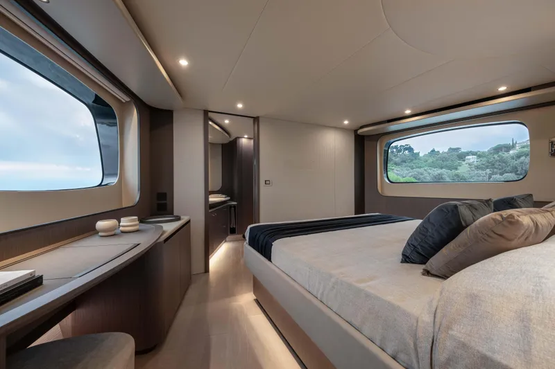 Slide: The Image of Luxurious interior of 2026 Absolute Navetta 58 yacht, featuring spacious bedroom with large windows. - 40
