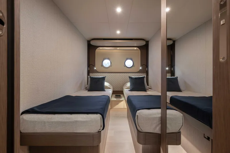 Slide: The Image of Luxurious twin cabin interior on 2026 Absolute Navetta 58 yacht, featuring modern design and cozy bedding. - 49
