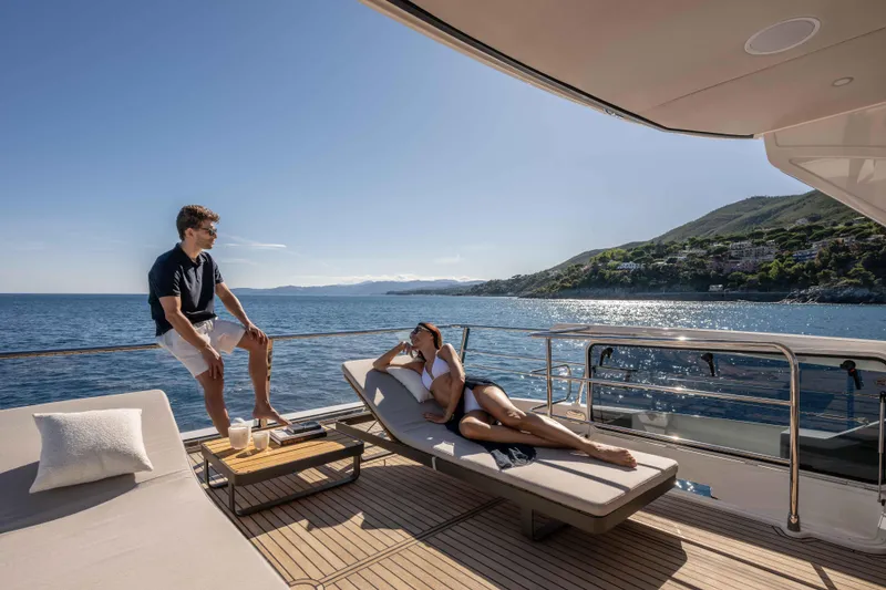 Slide: The Image of Two people relaxing on the deck of a 2026 Absolute Navetta 58 yacht. - 28