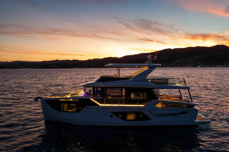 Slide: The Image of 2026 Absolute Navetta 58 yacht at sunset, illuminated on calm waters. - 57