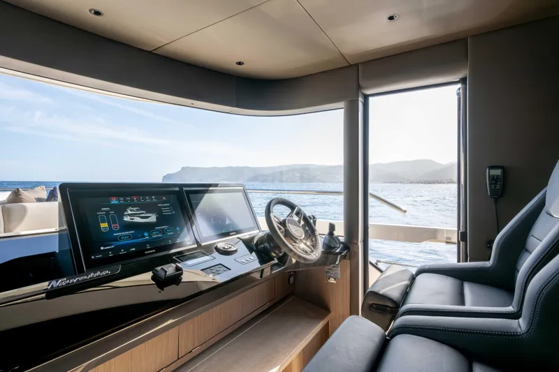 Slide: The Image of Interior view of 2026 Absolute Navetta 58 yacht cockpit with modern navigation screens. - 34