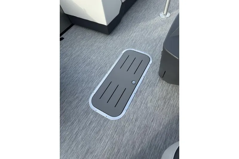 Slide: The Image of 2026 Bennington S 22 SSR boat floor with storage hatch, gray textured surface. - 10