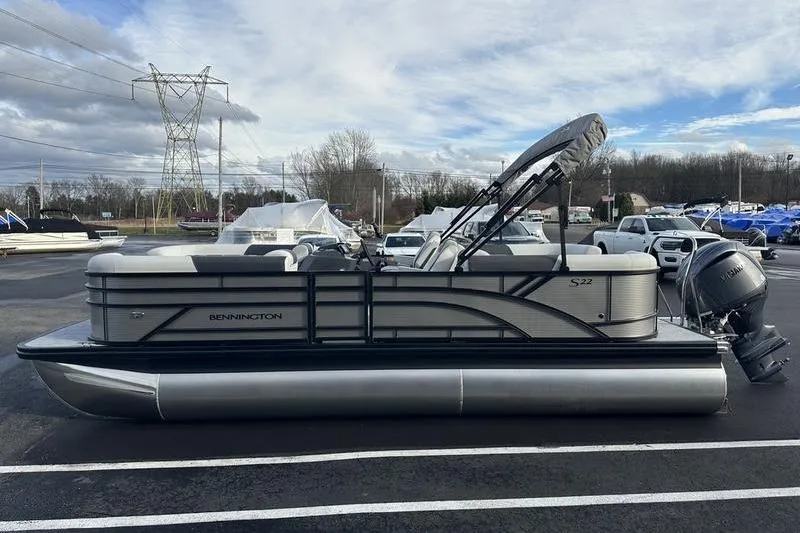 Slide: The Image of 2026 Bennington S 22 SSR pontoon boat parked outdoors on a cloudy day. - 3