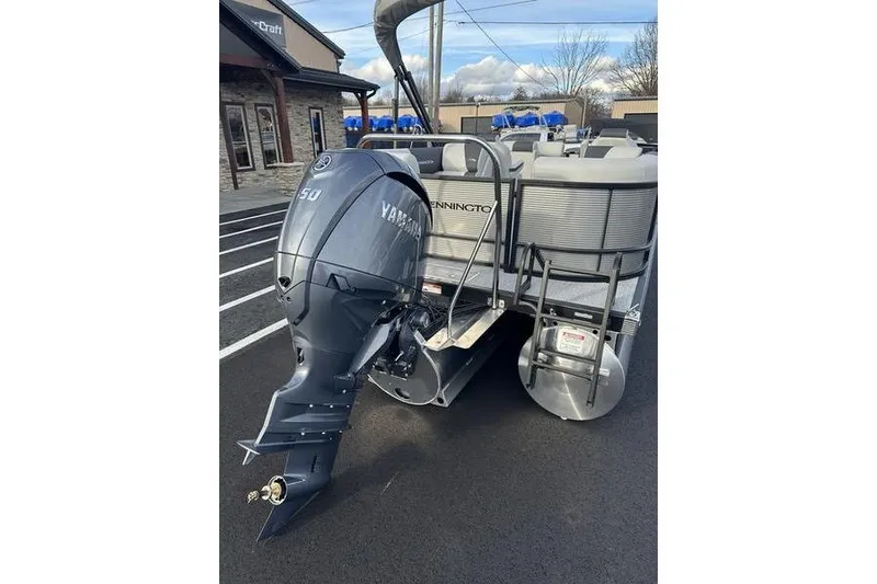 Slide: The Image of 2026 Bennington S 22 SSR pontoon boat with Yamaha 50 engine, parked outdoors. - 6