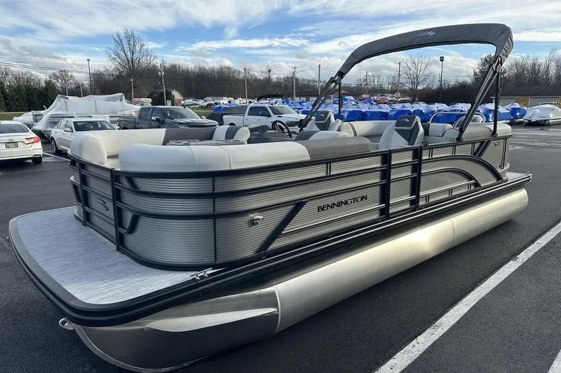 Slide: The Image of 2026 Bennington S 22 SSR pontoon boat in a parking lot, showcasing sleek design. - 7