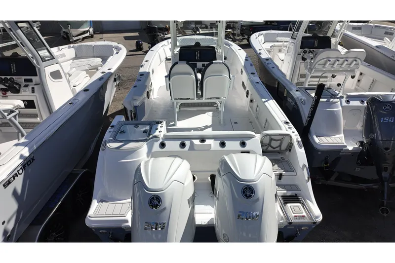 Slide: The Image of 2026 Sea Fox 268 Commander boat with dual engines, docked among similar vessels. - 17