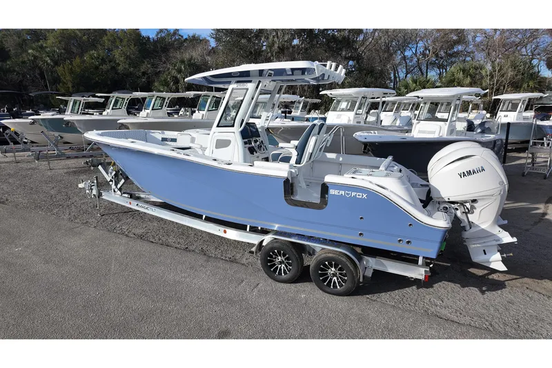 Slide: The Image of 2026 Sea Fox 268 Commander boat on trailer, featuring Yamaha engine, in outdoor showroom. - 2