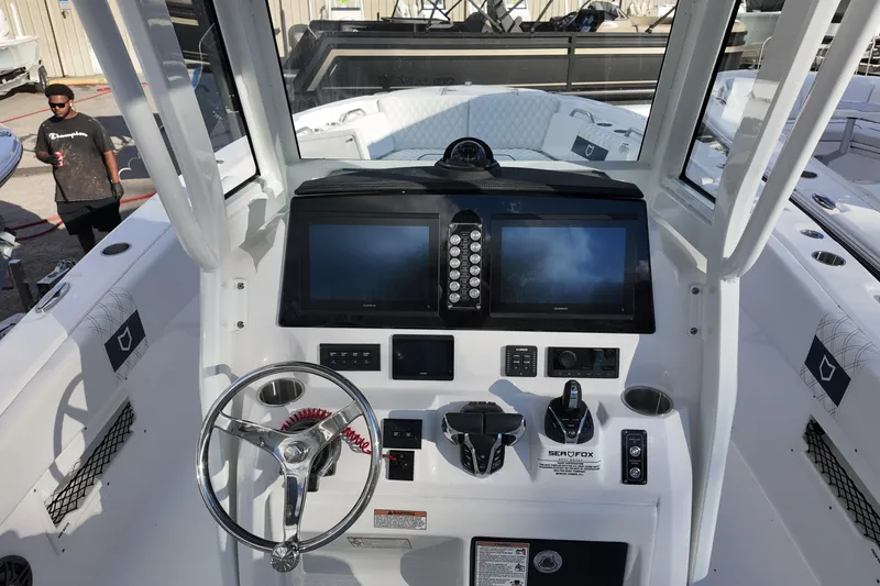 Slide: The Image of 2026 Sea Fox 268 Commander boat dashboard with dual screens and steering wheel. - 5