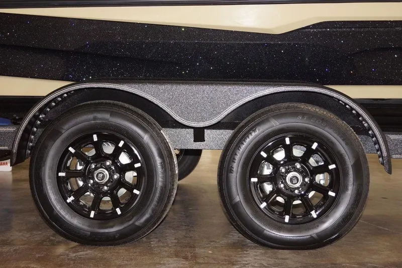 Slide: The Image of 2020 Skeeter ZXE20 trailer with dual black alloy wheels and sparkly black finish. - 2