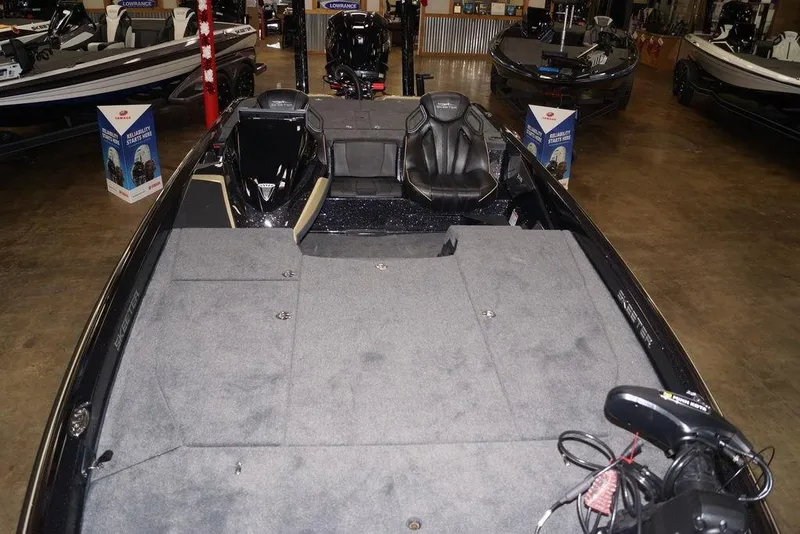 Slide: The Image of 2020 Skeeter ZXE20 boat interior with carpeted deck and seating in showroom. - 23