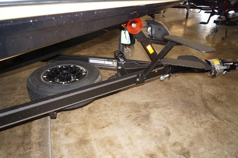 Slide: The Image of 2020 Skeeter ZXE20 boat trailer with black wheel and sturdy frame. - 27