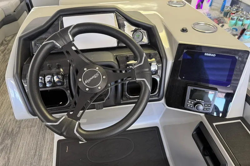 Slide: The Image of 2026 Bentley Pontoons Elite 253 Swingback dashboard with steering wheel and Simrad display. - 5