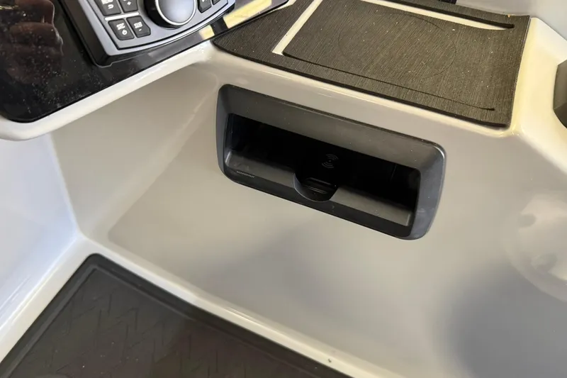 Slide: The Image of 2026 Bentley Pontoons Elite 253 Swingback dashboard with control panel and storage compartment. - 6