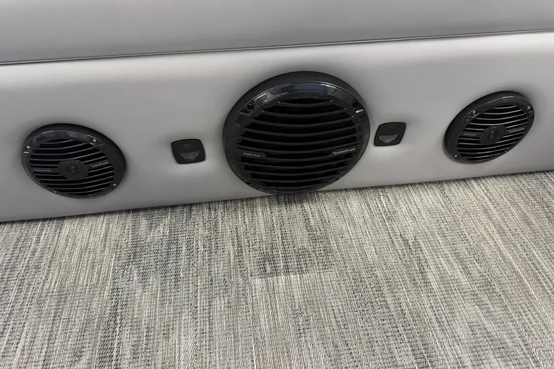 Slide: The Image of 2026 Bentley Pontoons Elite 253 Swingback interior speakers on textured flooring. - 9